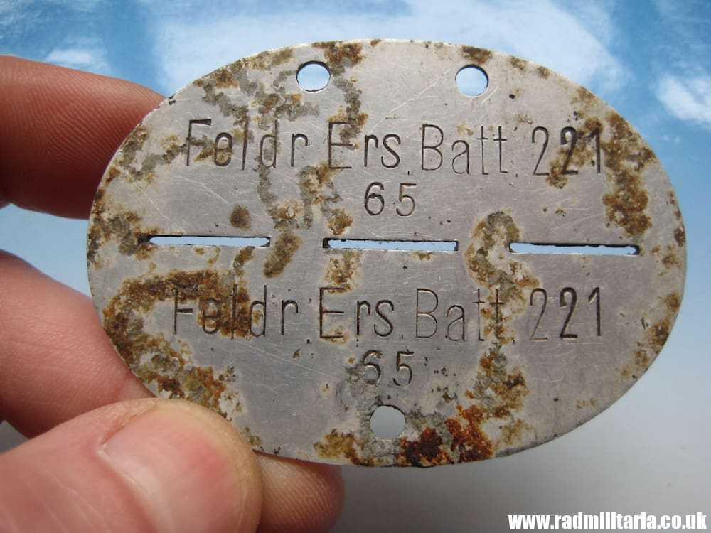 & original German DOG TAG - ID DISC metal detecting find: FELDR. ERS. BATL. 221. 65.
