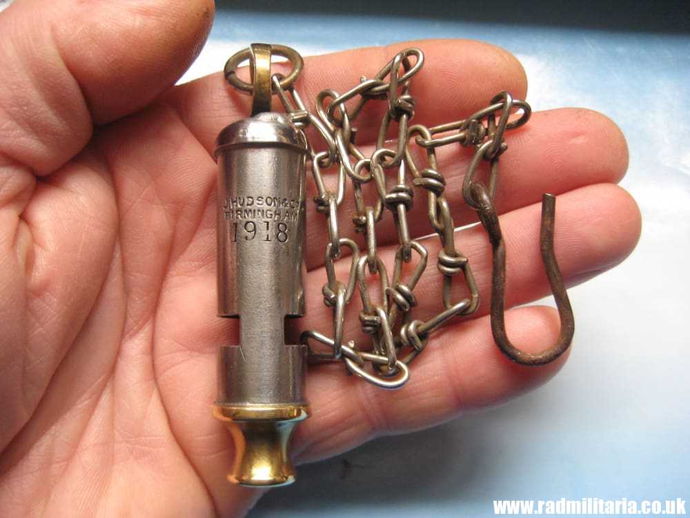 & WW1 original British MILITARY WHISTLE with date 1918 and metal chain: J. HUDSON & Co BIRMINGHAM.