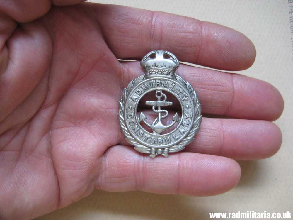 & post WW2 original British METAL BADGE - ADMIRALTY CONSTABULARY white metal cap badge..