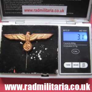 & original German KRIEGSMARINE EAGLE BADGE - gold color CAP BADGE in good condition.