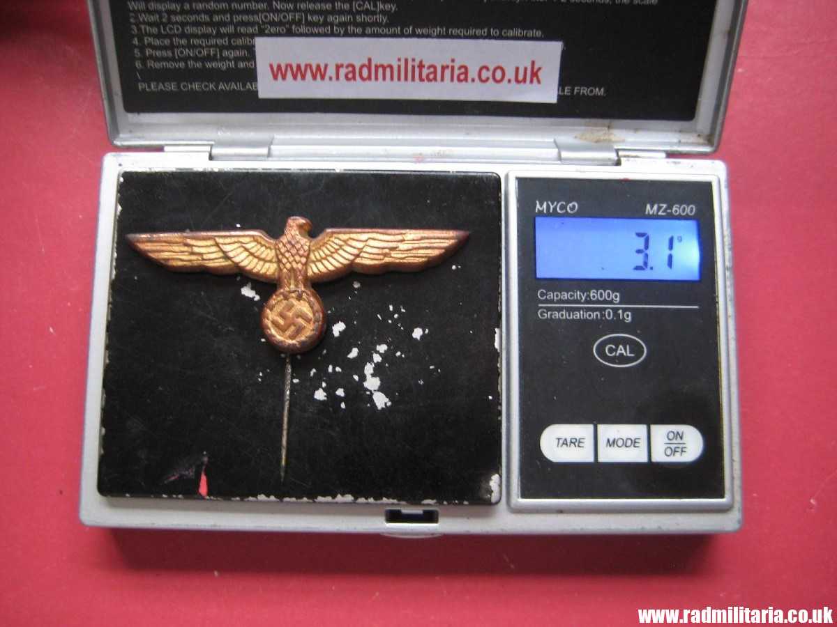 & original German KRIEGSMARINE EAGLE BADGE - gold color CAP BADGE in good condition.