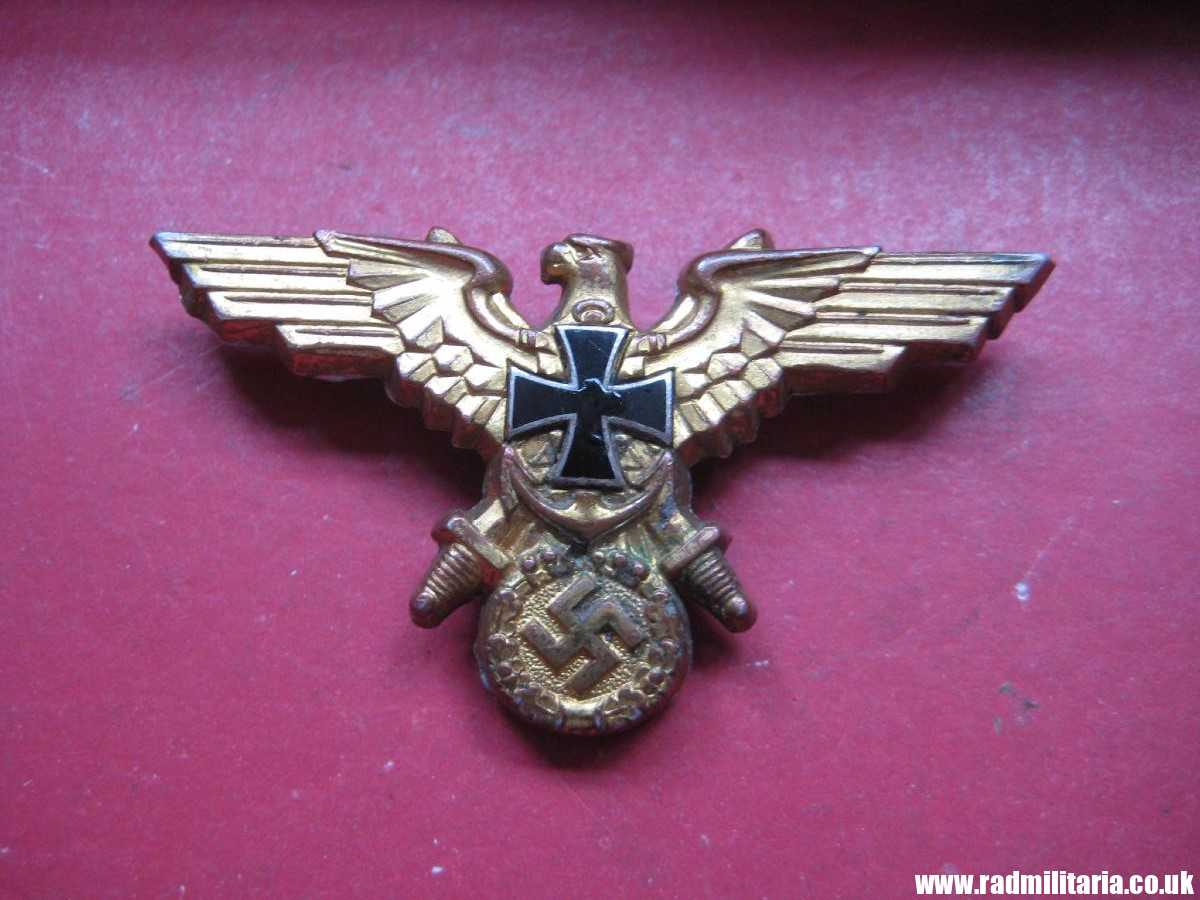 & original German KRIEGSMARINE EAGLE BADGE - gilded BADGE marked: GES. GESCH.