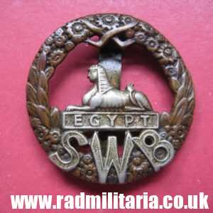 & WW1 original British CAP BADGE - South Wales Borderers with old repairing.